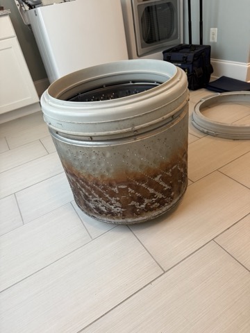 Washer tub pulled out for cleaning